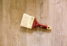 4 quick home value improvement tips before summer Paint brush on the floor